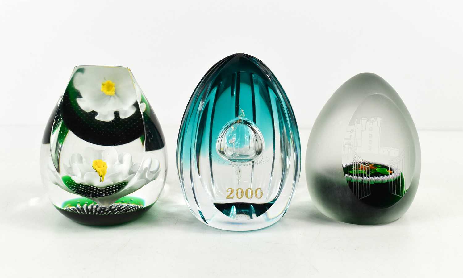 Three Caithness of Scotland glass paperweights: Daisy Daisy 257/350, Castle of Mey 19/100, and 2000,