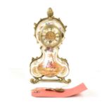 A French porcelain mantle clock, with roman numerals ot the chapter ring, and pierced hands, the