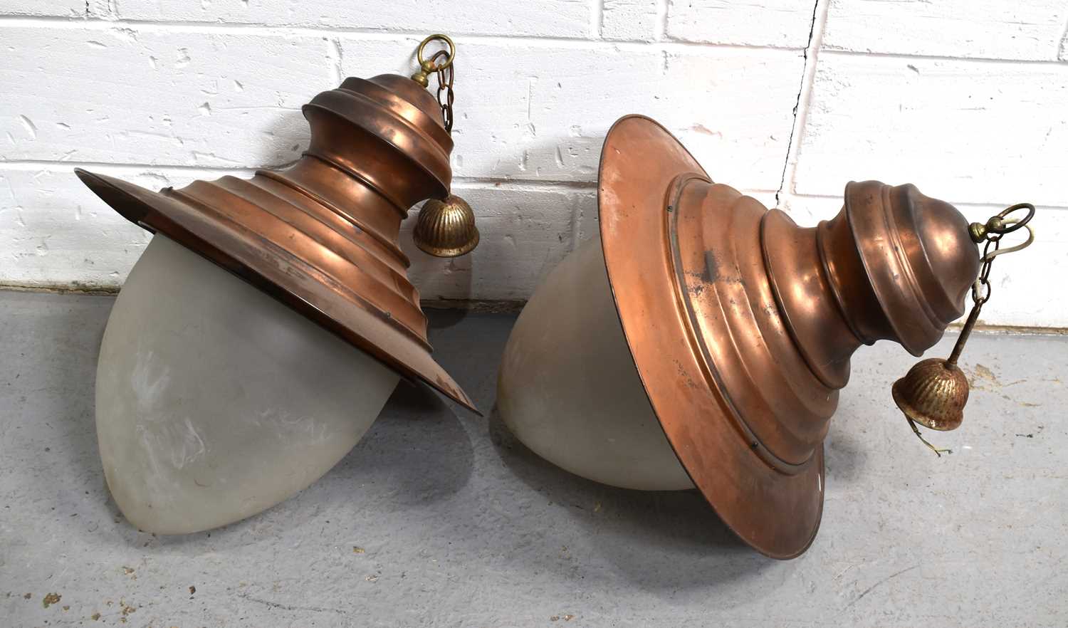 A pair of large industrial coppered metal lanterns with opaque glass shade, 76cm high.