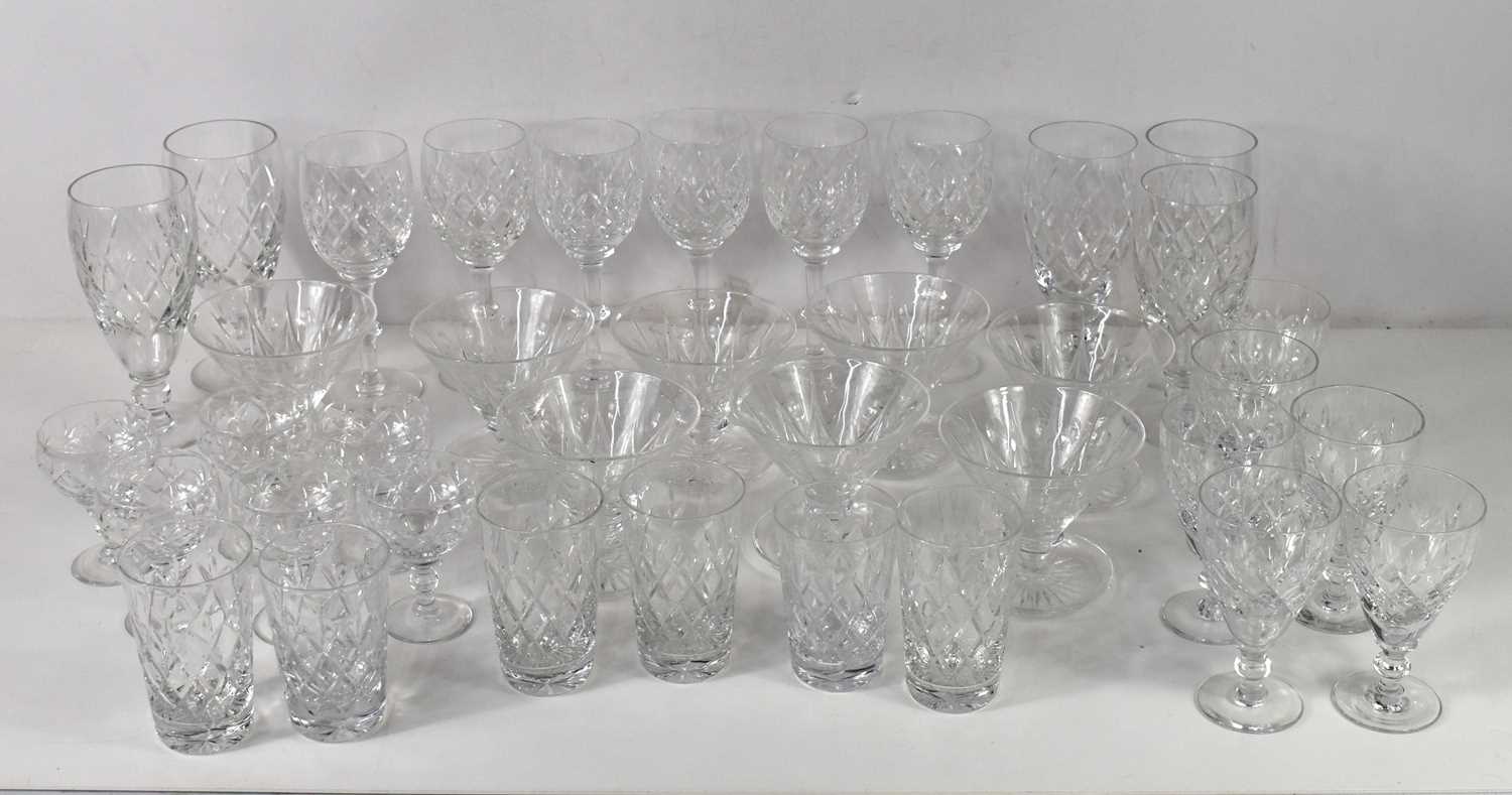 A part suite of cut glass tablewares comprising five large goblets, six tall wine glasses, six
