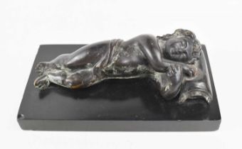 A small bronze of a sleeping child, his head resting on a fringed cushion, possibly early 19th