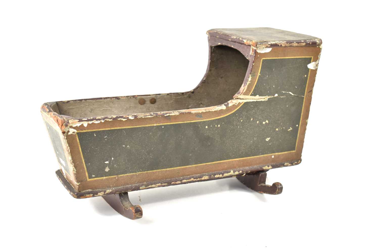 An antique dolls rocking cradle with residual paintwork, 39cm by 24cm high.