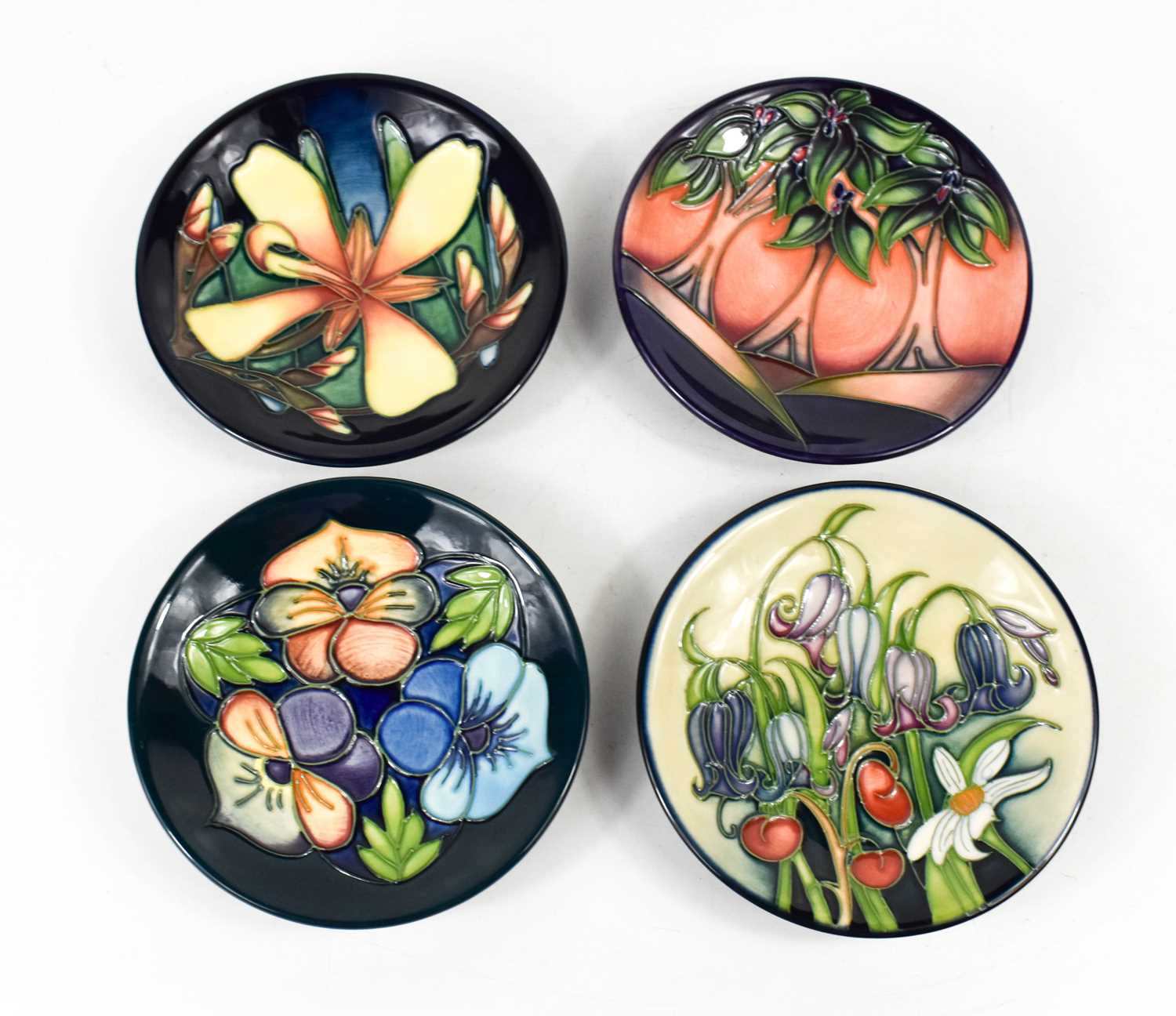 A group of four Moorcroft pottery dishes, to include one by Emma Bossons dated 2005, two by Rachel