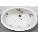 A porcelain sink of oval form, decorated with sprigs of spring flowers, by Johnson brothers, Stoke