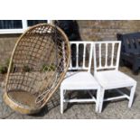 A vintage rattan swinging egg chair together with two painted chairs