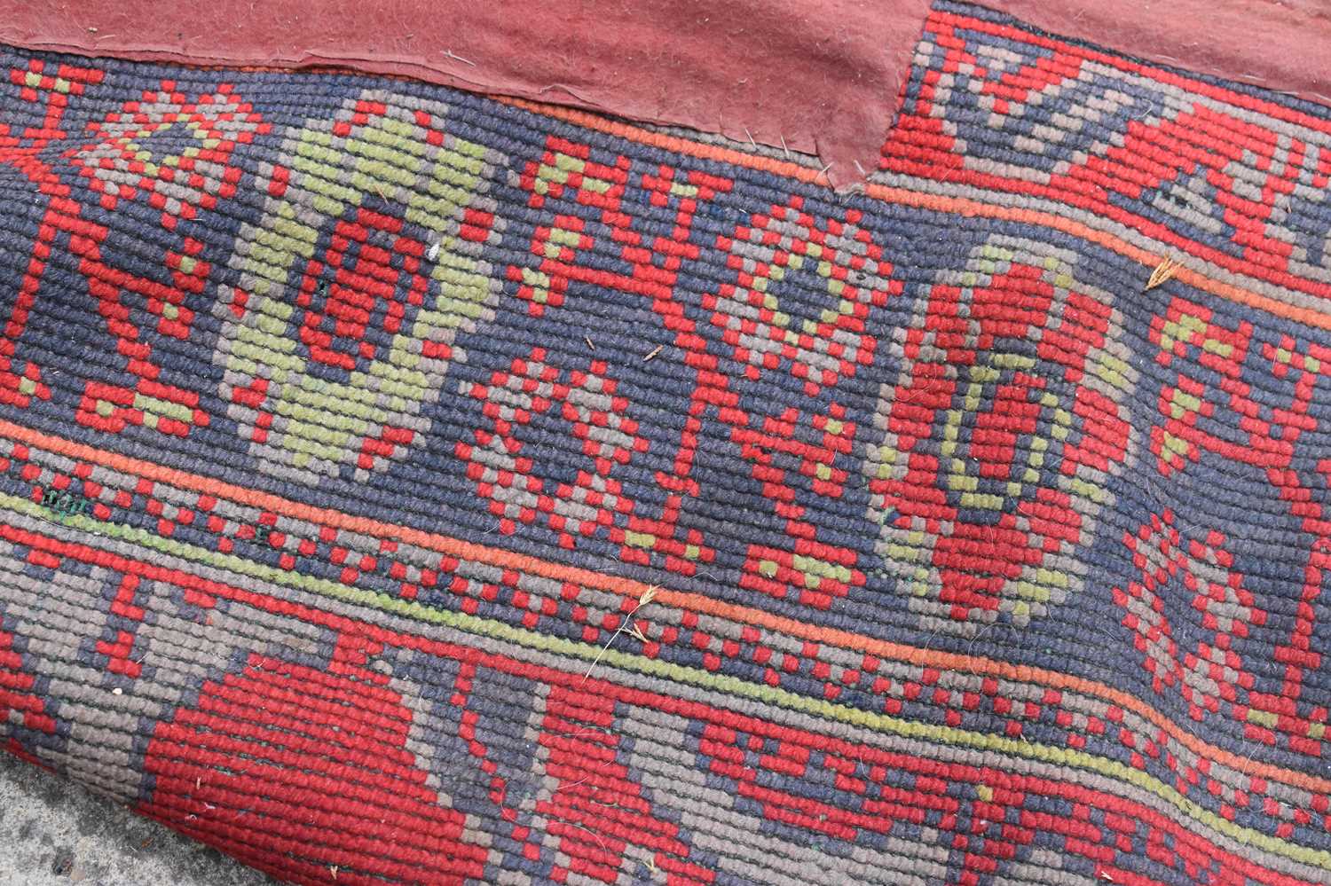 Two antique wool rugs likely Middle Eastern origin both with red ground and stylised motifs and - Bild 9 aus 13