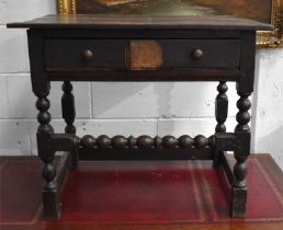 A 17th century oak side table with single geometric moulded drawer and bobbin turned front rail