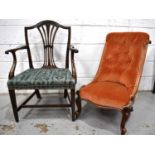 A Victorian mahogany nursing chair with orange velor upholstered button back raised on ceramic