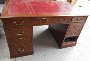 A mahogany twin pedestal desk, with gilt tooled burgundy slip, and swan neck handles, 137 by 77 by