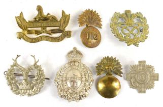 A group of Victorian and later cap and pouch badges to include Gordon Highlanders, 64th Foot