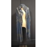 An Art Deco Egyptian Assuit shawl, the blue linen net with hammered silver abstract design, 78 by