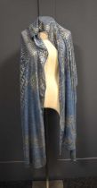 An Art Deco Egyptian Assuit shawl, the blue linen net with hammered silver abstract design, 78 by