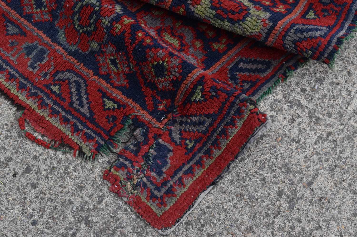 Two antique wool rugs likely Middle Eastern origin both with red ground and stylised motifs and - Image 4 of 13
