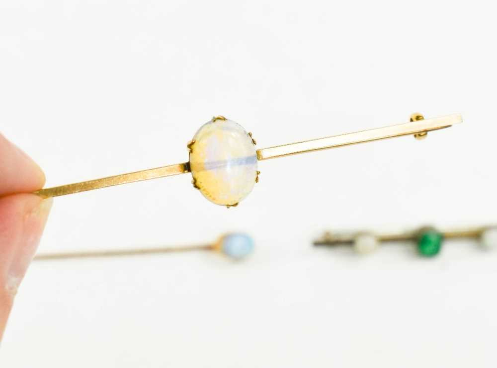 A 9ct gold and opal set bar brooch 7½cm long, the oval opal cabochon 13 by 9mm, 3.73g, a 9ct gold - Image 2 of 2