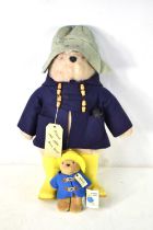 A vintage Paddington Bear wearing a hat, blue duffel coat, and Dunlop yellow wellies, 50cm, together
