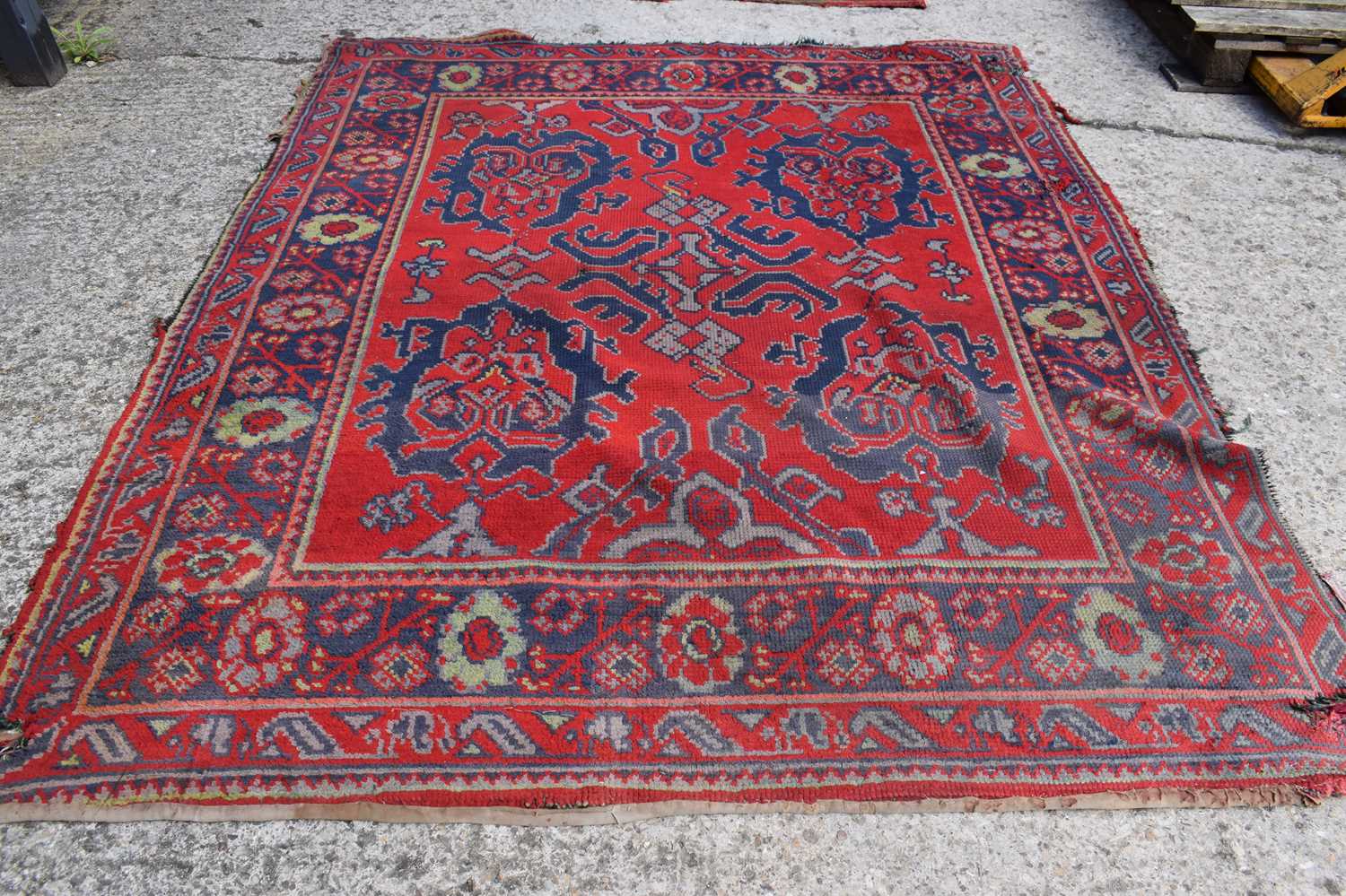 Two antique wool rugs likely Middle Eastern origin both with red ground and stylised motifs and - Image 2 of 13