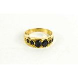 A 9ct gold and sapphire six stone ring, size O, 3.10g.