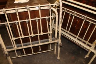 Two Victorian wrought iron painted single bed frames.