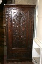 Jacobean revival chip carved oak cupboard with panel door above base drawer, raised on plinth,