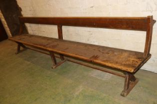 Antique mahogany bench with X-form trestle end, 295cm long.