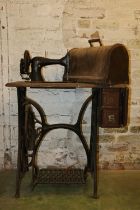 Vintage Singer sewing machine on treadle base.
