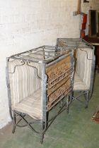 Pair of white metal folding beds with sprung bases, raised on castors, 80cm wide.