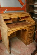Oak roll top desk with kneehole and pedestal of drawers, the tambour front opening to reveal