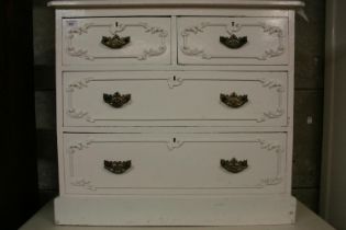 Antique cream painted chest of drawers with applied scrolling foliage sprays, having two short