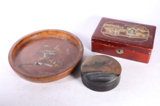 Chinese lacquered hinge top box, 20cm long and a circular tray with gilded relief floral decoration,