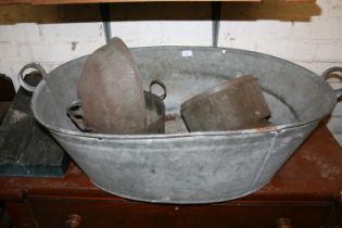 Antique metal twin handled bath and contents.