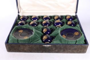 Japanese Satsuma coffee set with Bristol Blue ground and gilt floral decoration in fitted case.