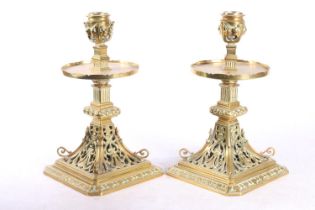 Pair of pierced brass candlesticks with circular galleries platform drip trays raised on square