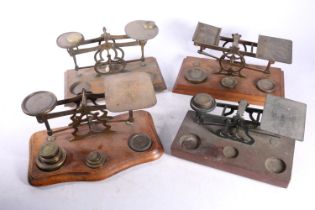 Four sets of postal scales with weights. (4)