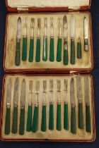 Part set of Art Deco fruit knives and forks with silver collars and green handles in fitted cases by