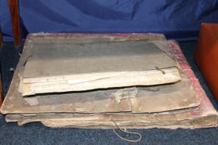 Three large antique book binders with a quantity of unused paper.