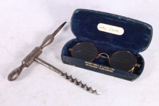 Unmarked steel corkscrew and a pair of tortoiseshell rimmed spectacles.  (2)