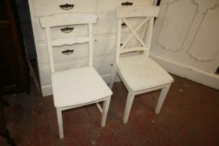 Two cream painted side chairs.