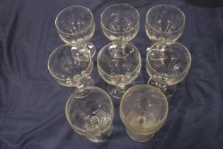 Set of eight glass rummers, 15cm high.