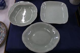 Three oriental celadon dishes, possibly Korean, the largest 26cm wide.