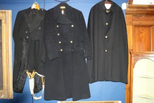 Two British naval overcoats and other uniform.