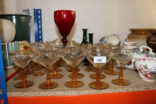 Part suite of Czechoslovakian glass with gilt decoration, two green glass ewers, a cranberry glass