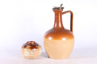 Doulton Lambeth stoneware ewer with silver top, having gadrooned thumb piece, 23cm high, and a