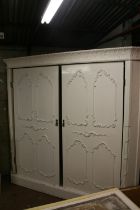 Large French style corner wardrobe, the ornate cornice with acanthus leaf and berry design above two
