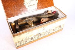 Box containing a antique brass water sprinkler, two wooden cask barrel taps, corkscrews, etc.