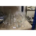 Glassware to include drinking glasses, a mallet shaped decanter, etc.