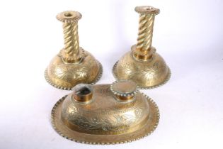 Dutch repousse brass desk set comprising a pair of candlesticks and a deskstand with two