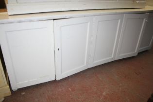 Antique cream painted five door cupboard top with moulded cornice, on base, 284cm long x 253cm high.