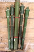 Green painted metal sceptre case, 63cm long, and four green painted wooden batons, 55cm long.