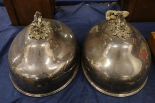 Two large silver-plated cloches with ornate oak leaf and acorn handles.