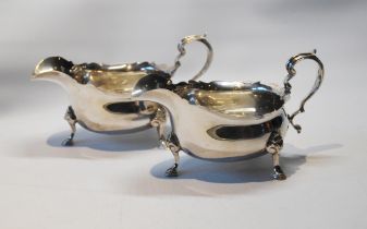 Pair of silver sauce boats of George II style with cut edges, on pad feet, Adie Brothers, Birmingham